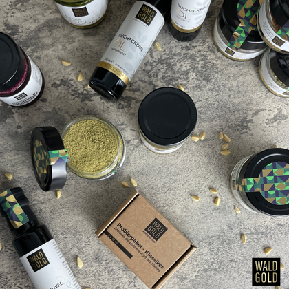 Eine ansprechende Anordnung von Produkten auf einem Tisch, darunter Öle und Pulver in stilvollen Glasbehältern. Einzelne Nüsse sind verstreut, was das natürliche Thema unterstreicht.